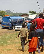 malawian mother and her children walking to the WFP wellness cenre