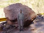 WFP staff member standing in front of the giant rock that killed his colleague