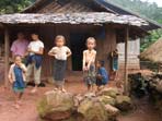 young children standing on the porch of their home