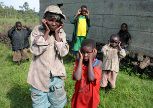 young children holding their ears