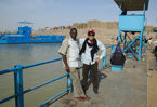Rocky Oshi and wfp team member posing by the river